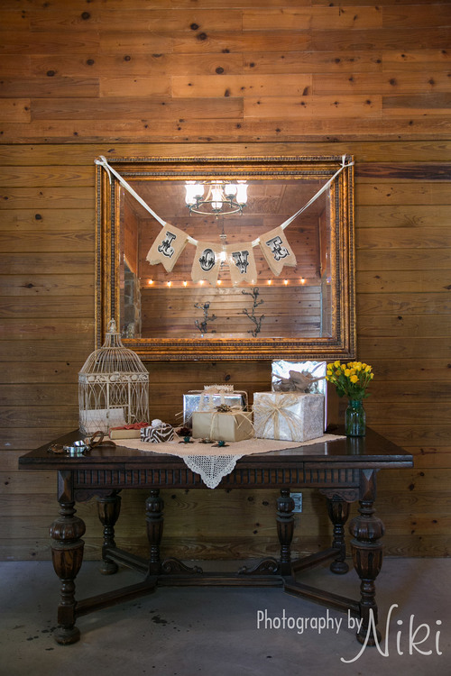Decorated gift table with rustic charm located in the foyer.