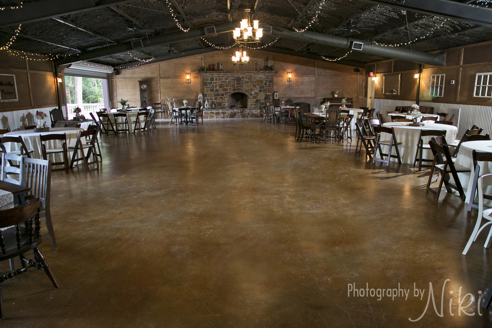 The Reception Hall decorated with rustic tables and chairs.