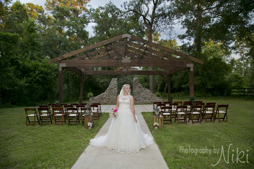 Ceremony Site with our open air Chapel, rock wall with antique gates and a beautiful bride.